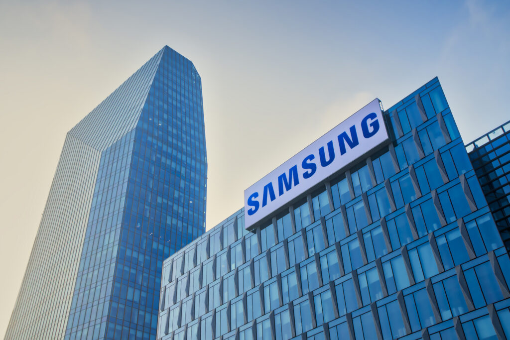 Glass office towers with a Samsung sign against a blue sky