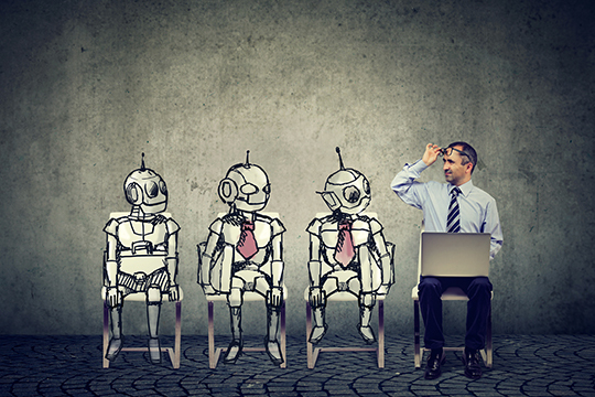 Man with a laptop sitting beside three robots on chairs, waiting for a job interview