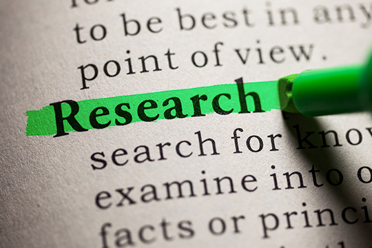 Dictionary page with the word research highlighted in green