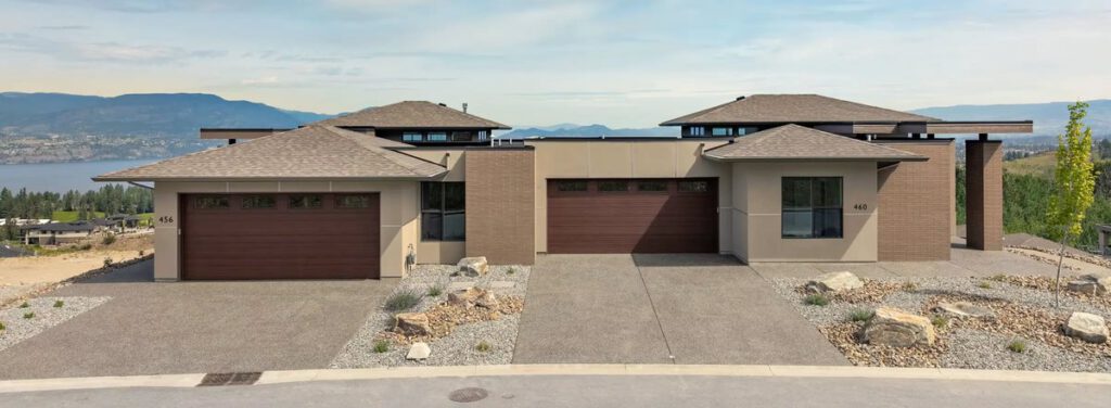Modern single-storey Kestrel Ridge home with two garage doors overlooking a lake
