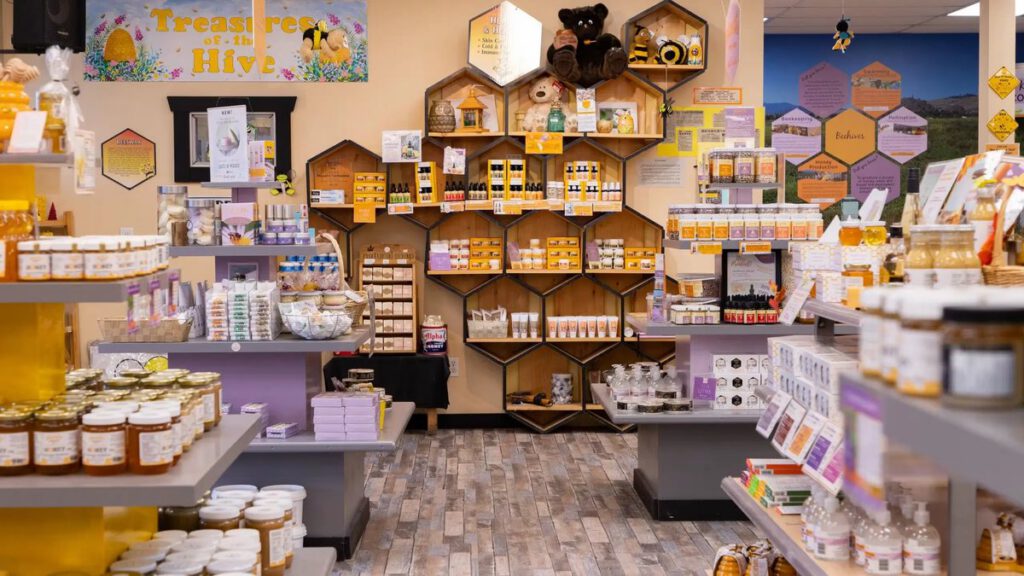 Planet Bee shop interior with honeycomb-shaped shelves of honey and bee products