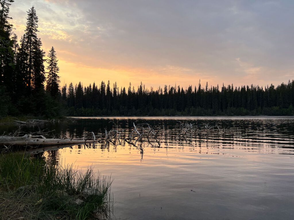 Sunset over a calm lake at the end of the trail