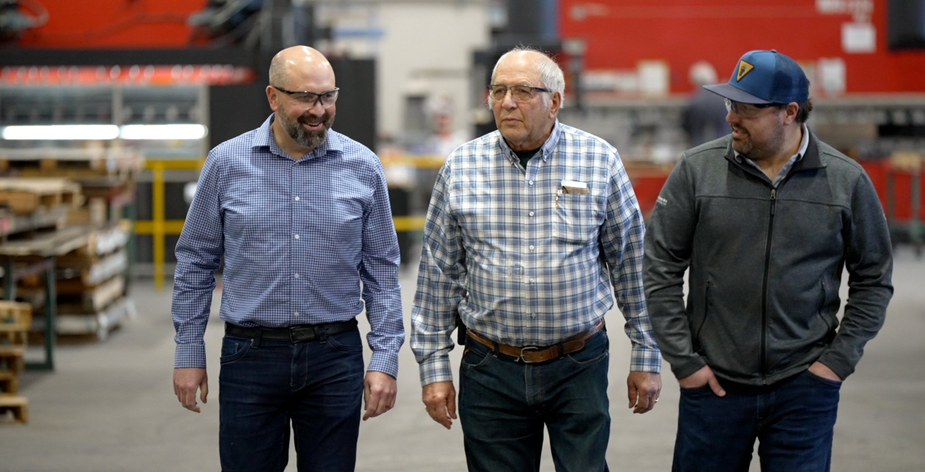 Three men walking through the GC Custom Metal Fabrication shop floor
