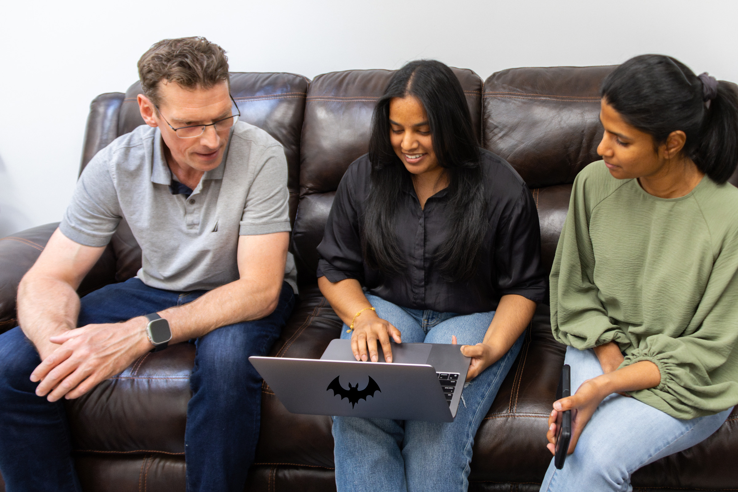 Three Twin Creek team members working on social media setup