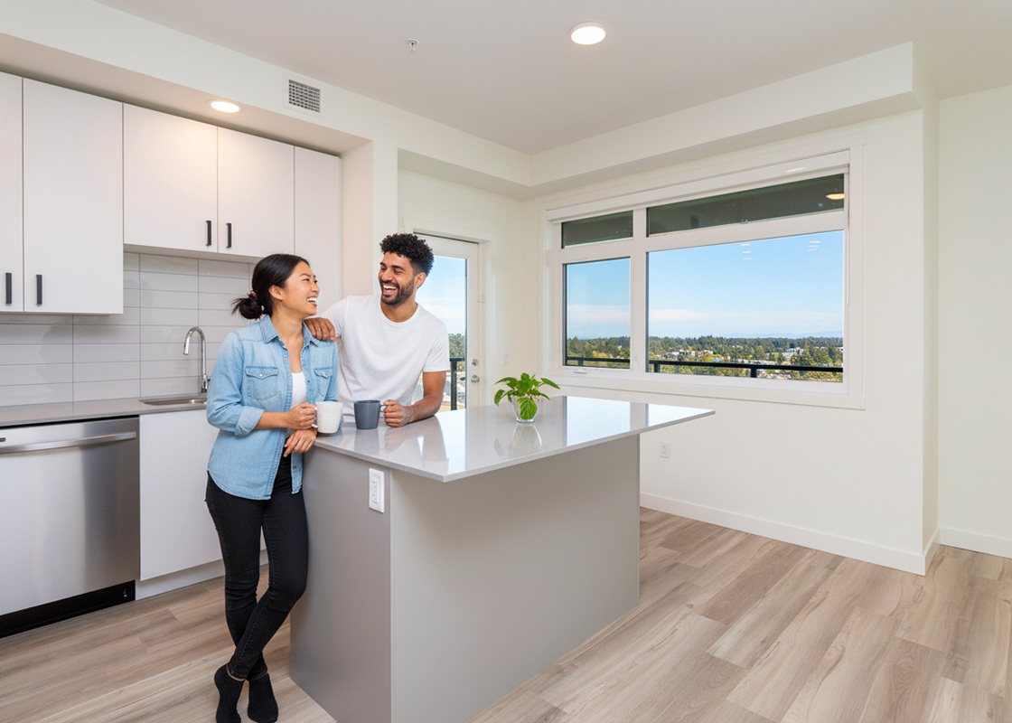 Couple laughing together in a bright new condo kitchen for Highstreet Ventures