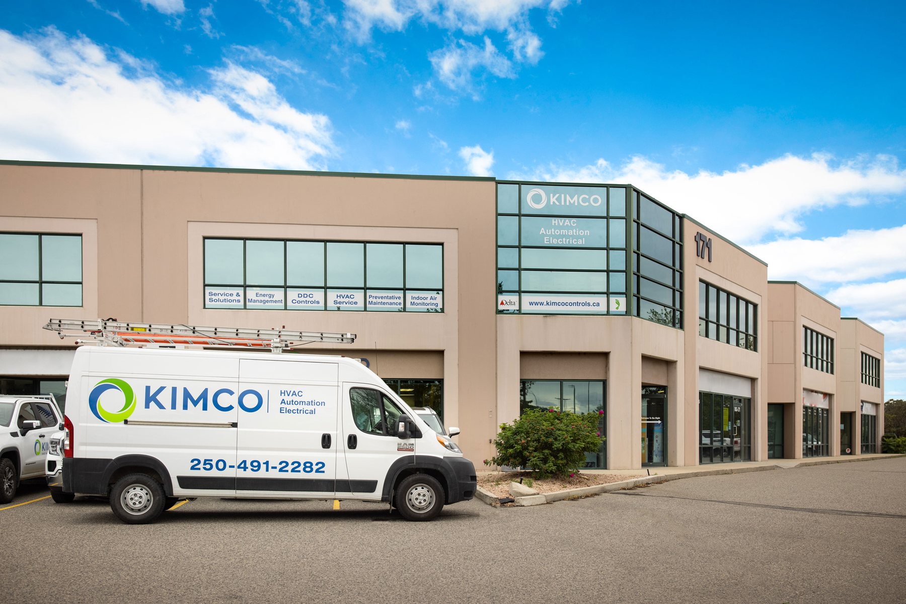 Kimco service van parked outside a commercial building