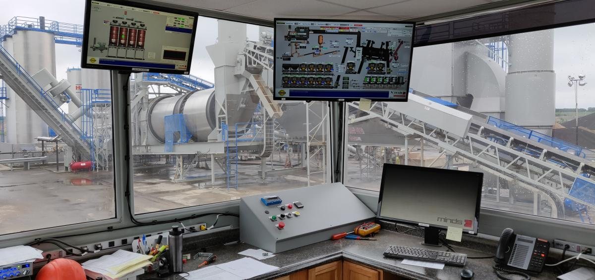 Control room with monitors overlooking an asphalt plant, for Minds Inc