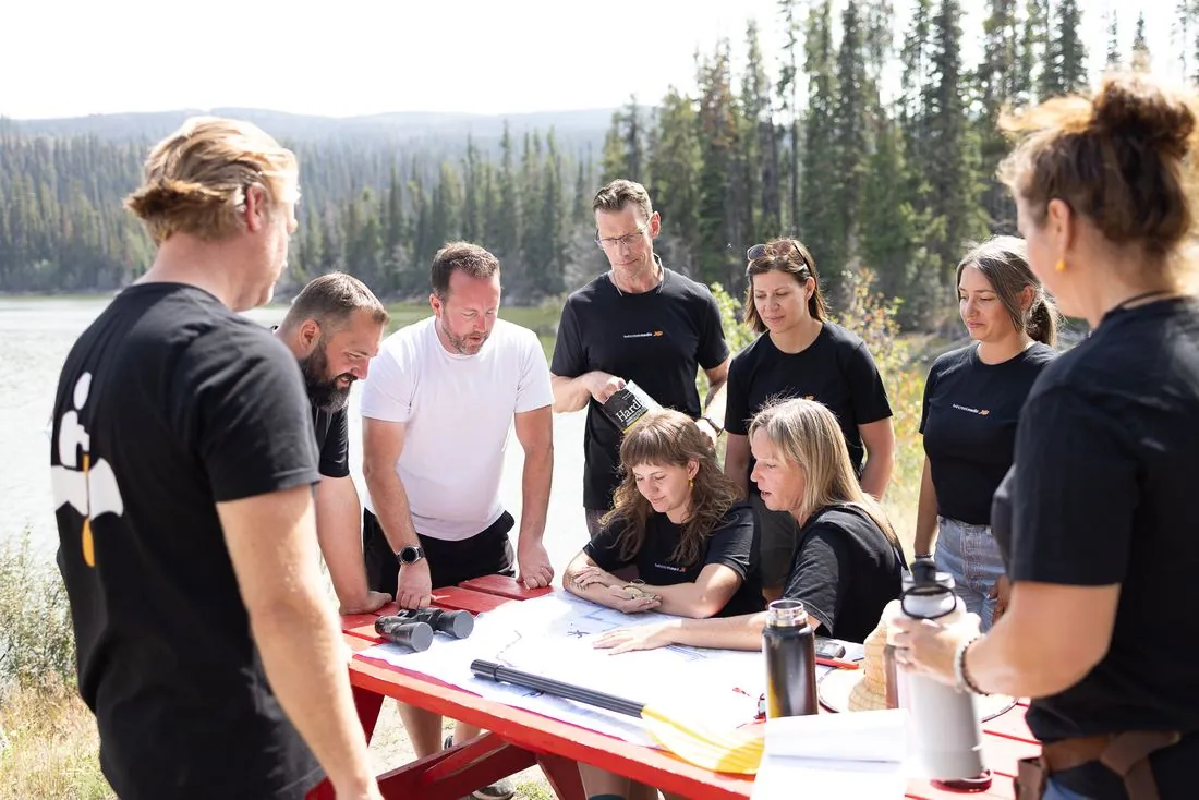 The team planning around a map on a picnic table